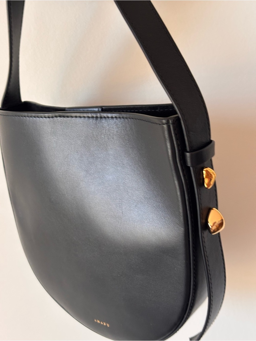 Black Half-Moon Leather Crossbody Bag with Gold Accents - Picture 2 of 6